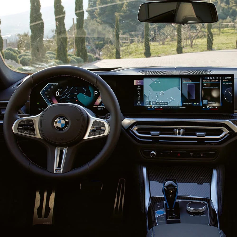 A driver's eye view of steering wheel and controls of the BMW i4 | BMW of Madison in Madison WI